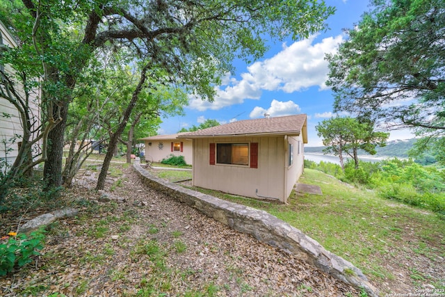 view of property exterior featuring a water view