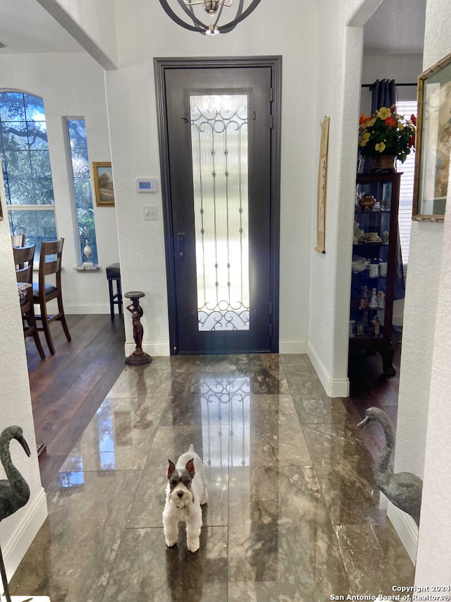 foyer featuring dark hardwood / wood-style floors and a notable chandelier