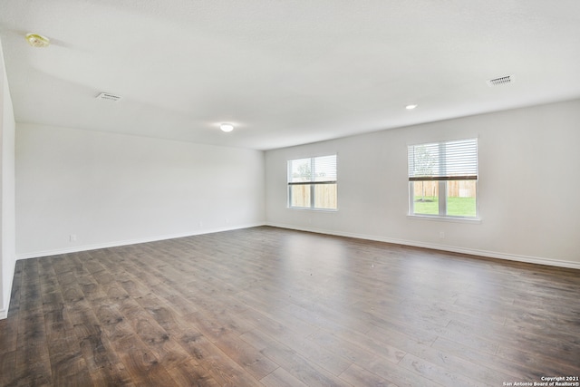 spare room with dark hardwood / wood-style flooring