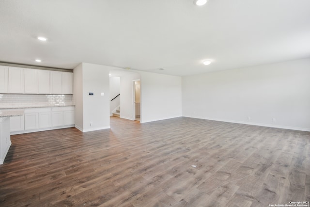 unfurnished living room featuring hardwood / wood-style floors