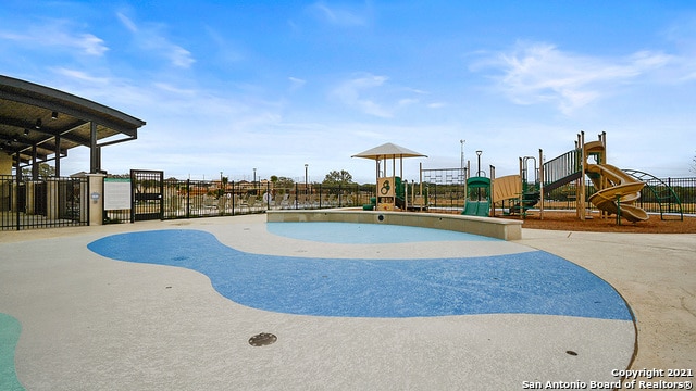 view of swimming pool with a playground