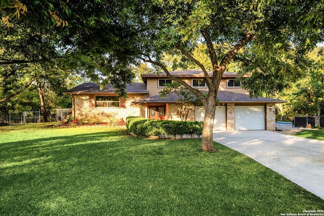 view of front of house with a garage and a front yard