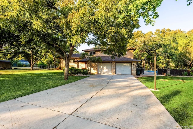 view of front of home featuring a garage and a front lawn