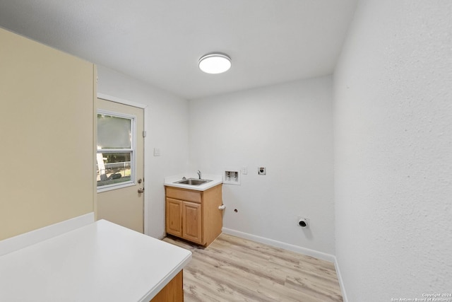 clothes washing area featuring washer hookup, sink, hookup for an electric dryer, cabinets, and light hardwood / wood-style floors