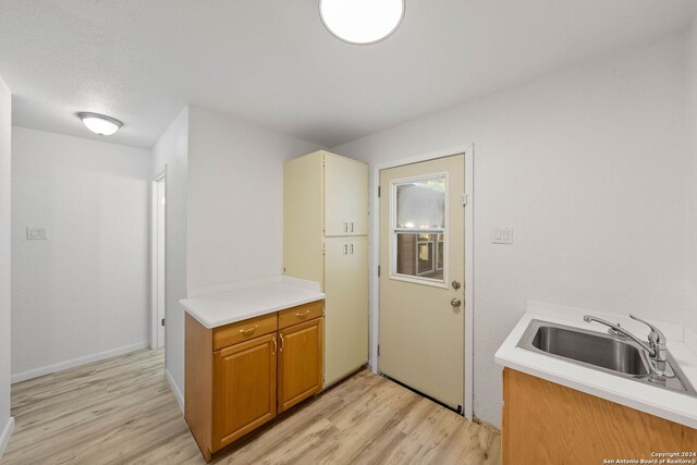 kitchen with light wood-type flooring and sink