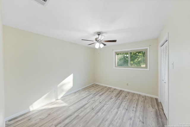 spare room featuring ceiling fan and light hardwood / wood-style floors