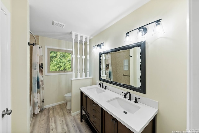 bathroom with curtained shower, hardwood / wood-style floors, vanity, and toilet