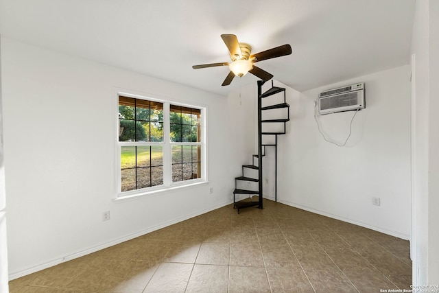 empty room featuring ceiling fan, tile patterned flooring, and a wall mounted AC