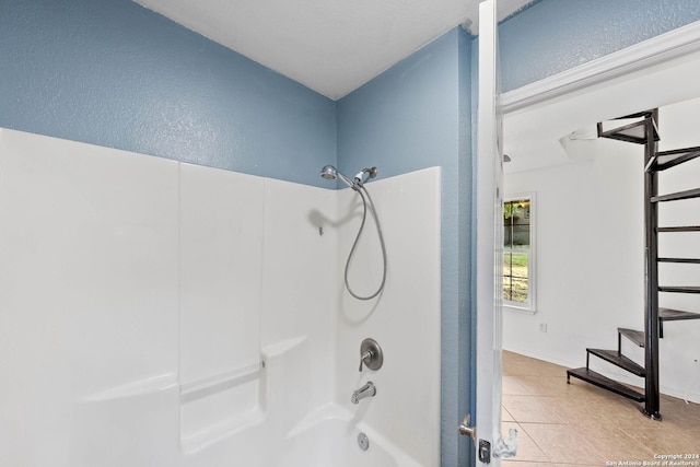 bathroom featuring tile patterned flooring and shower / bathtub combination