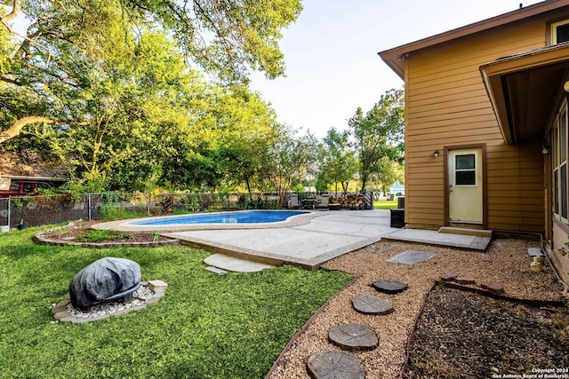 view of swimming pool featuring a lawn and a patio area