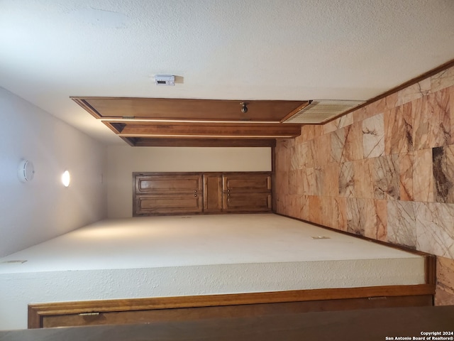 hallway featuring a textured ceiling