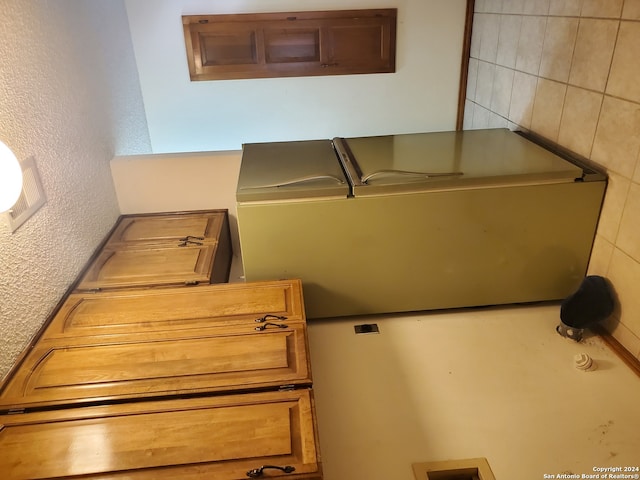 kitchen featuring tile walls