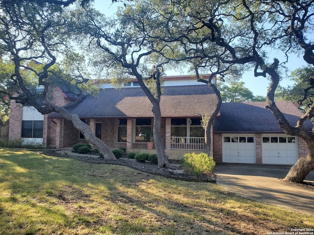 ranch-style home with a front lawn and a garage