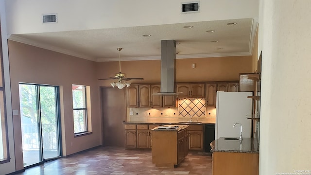 kitchen with ceiling fan, island range hood, sink, a center island, and white refrigerator