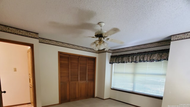 unfurnished bedroom featuring a closet, ceiling fan, and a textured ceiling