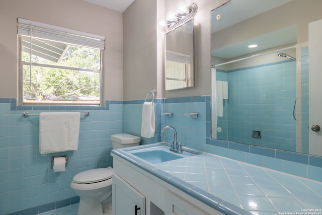 bathroom featuring vanity, tile walls, toilet, and walk in shower