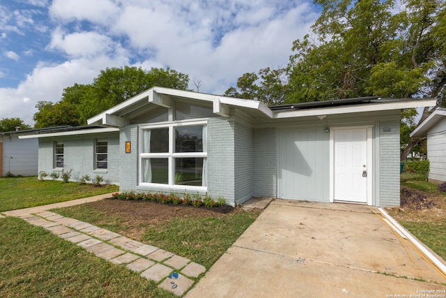 back of property featuring a lawn