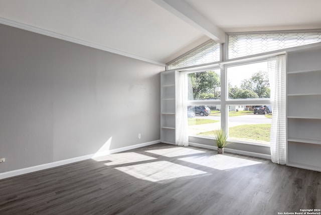 empty room featuring wood-type flooring and lofted ceiling with beams