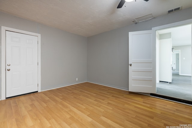 empty room with ceiling fan and light wood-type flooring