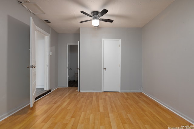 unfurnished bedroom with ceiling fan and light wood-type flooring