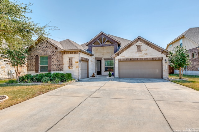 view of front of house featuring a garage and a front lawn