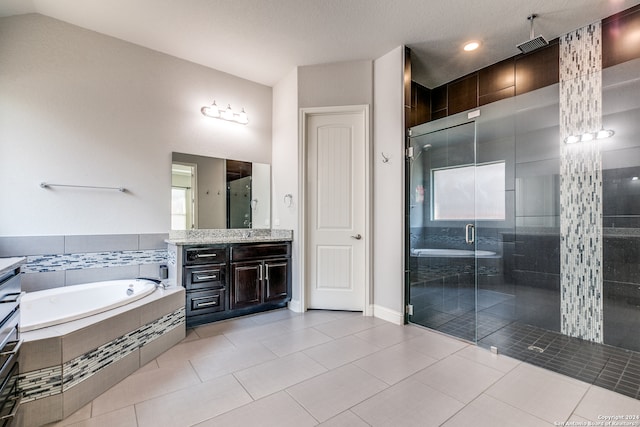 bathroom featuring independent shower and bath, vanity, lofted ceiling, and tile patterned floors