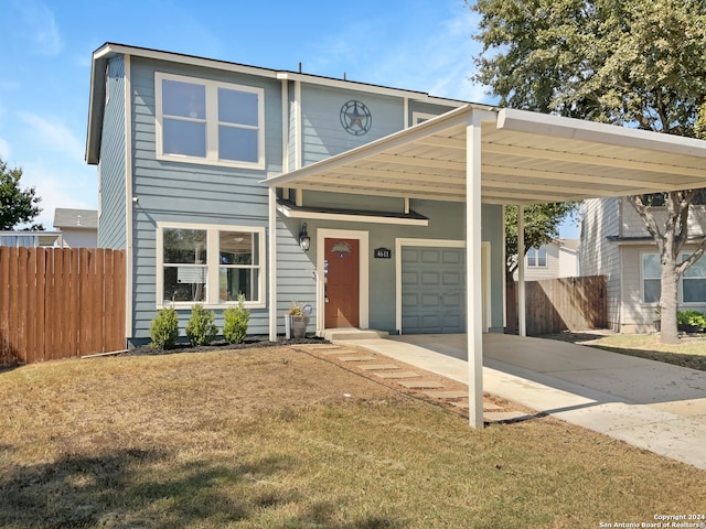 view of front of property with a carport, a garage, and a front yard