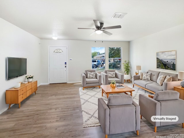 living room featuring light wood-type flooring and ceiling fan