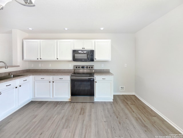 kitchen featuring electric stove, light wood-type flooring, sink, and white cabinetry