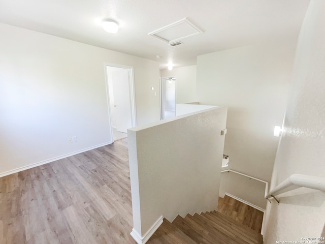 stairs featuring hardwood / wood-style flooring