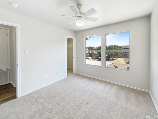 empty room with carpet and ceiling fan