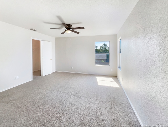 unfurnished room with carpet floors and ceiling fan