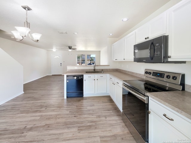 kitchen featuring black appliances, white cabinets, sink, pendant lighting, and light hardwood / wood-style flooring