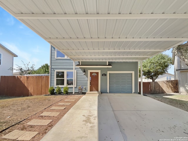 view of front of property featuring a garage and a carport