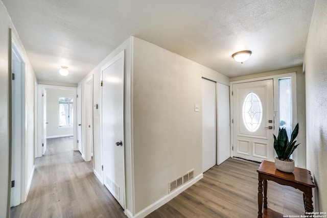 119 Rolling Grn, San Antonio, TX 78228 - foyer entrance with a textured ceiling, baseboards, wood finished floors, and visible vents