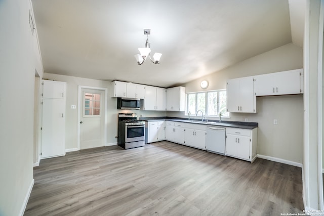 kitchen featuring appliances with stainless steel finishes, white cabinets, light hardwood / wood-style floors, and vaulted ceiling