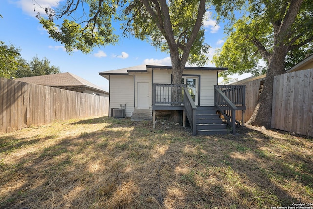 rear view of house featuring cooling unit