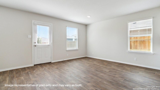 empty room with dark hardwood / wood-style flooring