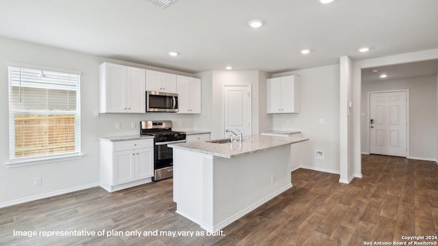 kitchen with an island with sink, light stone countertops, dark hardwood / wood-style floors, stainless steel appliances, and white cabinetry