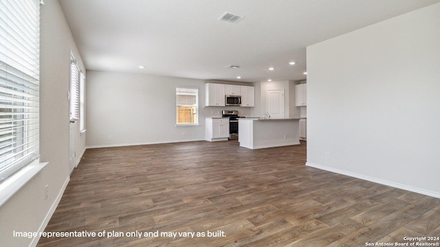 unfurnished living room featuring dark hardwood / wood-style flooring