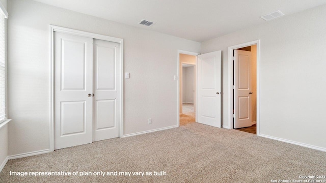 unfurnished bedroom featuring a closet and carpet flooring