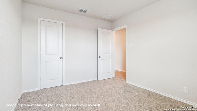 unfurnished bedroom with light colored carpet