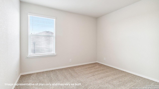 unfurnished room featuring light carpet