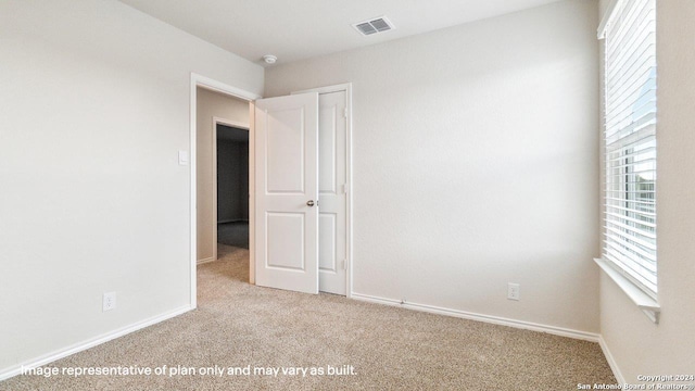 spare room with light colored carpet