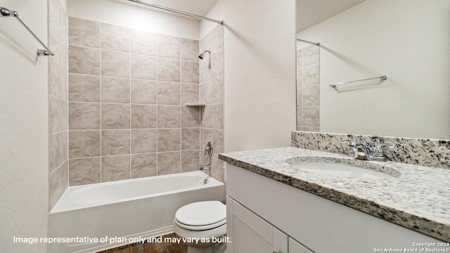 full bathroom featuring toilet, vanity, and tiled shower / bath combo