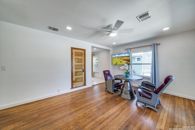 office area featuring hardwood / wood-style floors, a textured ceiling, and ceiling fan