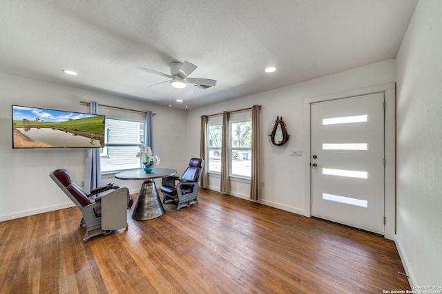 dining space featuring ceiling fan, wood-type flooring, and a textured ceiling