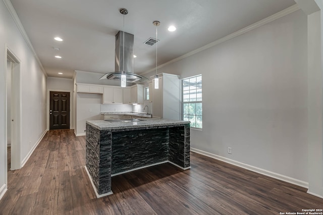 kitchen with light stone countertops, sink, dark hardwood / wood-style flooring, crown molding, and white cabinetry