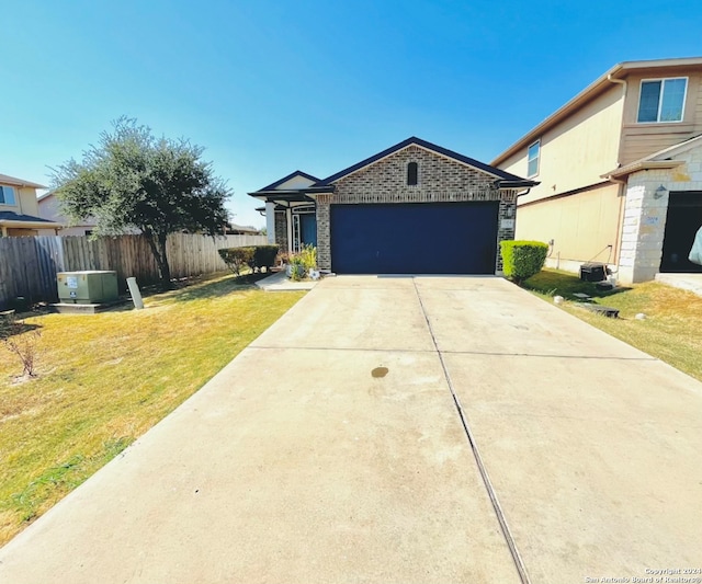 single story home with a front yard and a garage