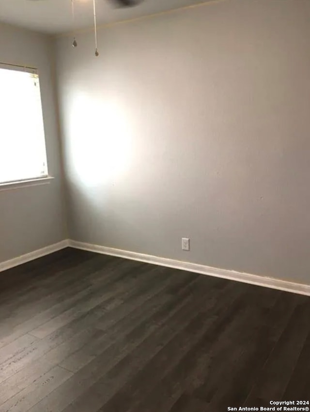 unfurnished room featuring dark hardwood / wood-style flooring